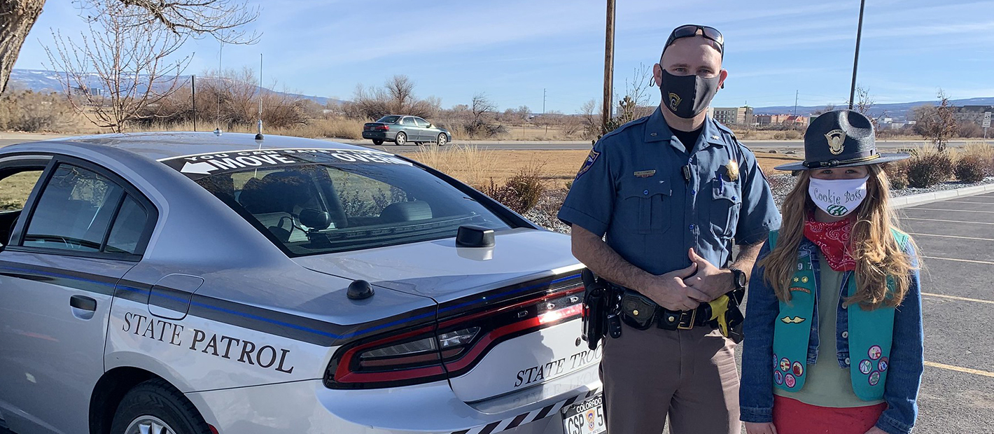  Photo of a Girl Scout with a Colorado State Patrol officer 