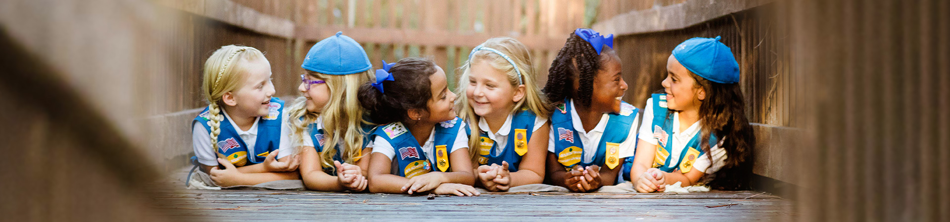  Photo of three girls hugging and smiling 