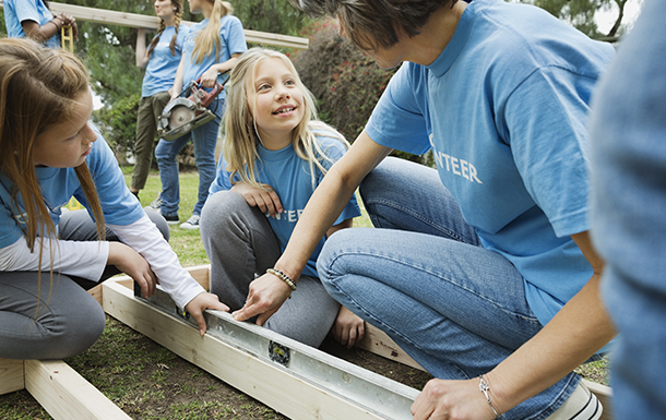 Photo of volunteers and girls in a community garden